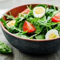 Egg Salad · Small egg salad with greens and fresh tomatoes.
