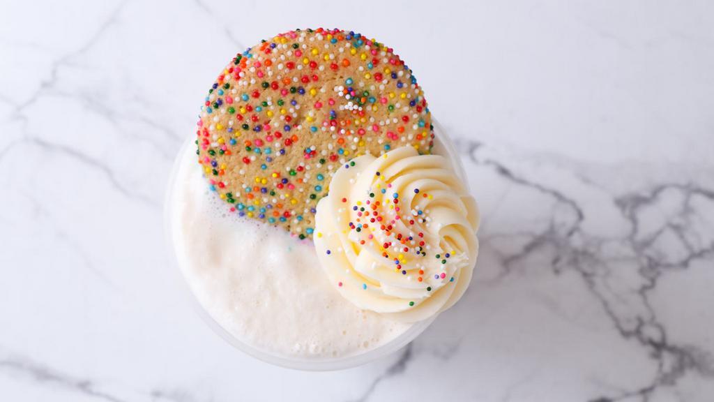 Birthday Cake Shake · Vanilla ice cream blended together with confetti cake pieces, vanilla frosting + Rainbow Sugar Cookie crumble. Party in a cup!