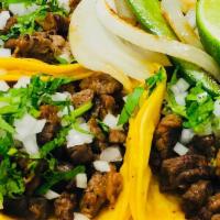 Regular Taco · Small corn tortilla, meat, onions and cilantro.