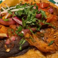 Pibil · Chicken pibil, marinated with onions and toasted habaneros, and served with refried black be...