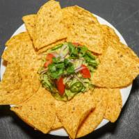 Guacamole & Chips · Made fresh with avocados, tomatoes, onions, jalapeños and lime. Served with a side of chips.