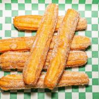 Churros · Homemade churros tossed in cinnamon sugar, side of maple syrup.