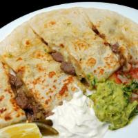 Regular quesadilla · Choice of meat, cheese, onions, cilantro, house red sauce and salad.