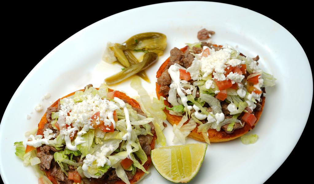  sopes · choice meat, cheese, lettuce, sour cream, red sauce,  pico de Gallo and fresh cheese.