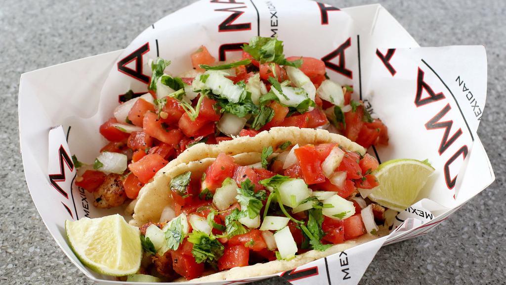 Tacos · Includes a made-to-order corn tortilla, choice of meat or veggies, topped with pico de gallo.