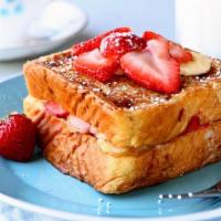 Strawberry banana french toast · French toast and banana strawberry  served with butter and syrup