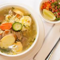 Chicken soup · Chicken ,soup with vegetables and noodles served with radish, cilantro, and chilies with hom...
