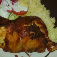 Pollo Asado · Oven-roasted chicken served with marinated onion, marinated cabbage,salad,  refried black be...
