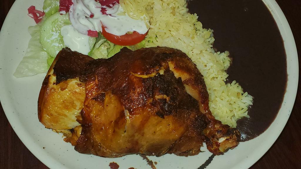 Pollo Asado · Oven-roasted chicken served with marinated onion, marinated cabbage,salad,  refried black beans, rice,and homemade tortillas.