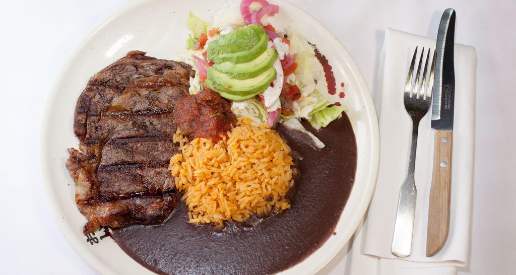 Carne Asada · 10oz ribeye  steak  serveď with rice beans and side salad
