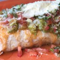 Macho Burrito · inside: refried beans, cheese, rice and choice of meat
topped with: burrito sauce, guacamole...