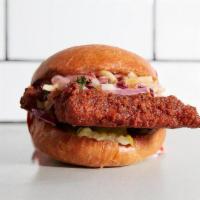 FRIED CHICKEN SANDWICH · Get it classic or spicy. House made apple slaw, mayo and pickles on a freshly toasted bun.