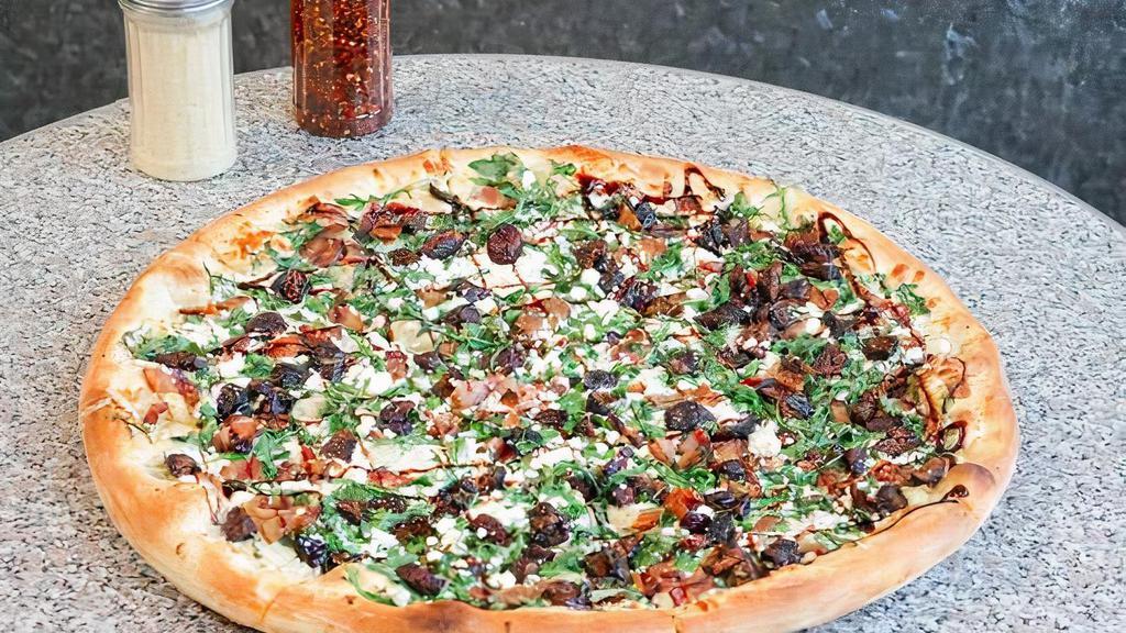 Gluten Free Miss Figgy Pizza · Eight slices. Crust brushed with olive oil and garlic, mozzarella, baby arugula, applewood smoked bacon, goat cheese, and sliced figs, drizzled with balsamic reduction.