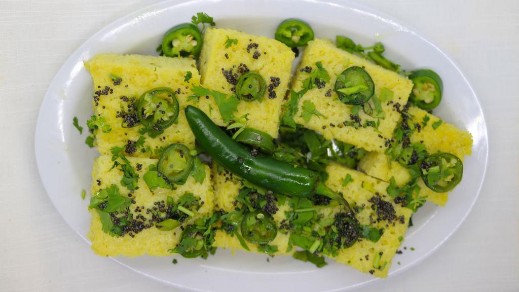 Khaman Dhokla (6-8 pcs.) · Khaman, is a popular Gujarati snack, made from Ground Gram Flour or Besan. Dhokla, is made with a batter made using rice and chickpeas. Traditionally it is steamed in a stovetop.