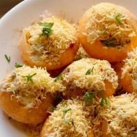 Sev Puri Chaat · Round crispy wafers topped with potato, chickpeas and sweet and spicy Chutneys sprinkled wit...