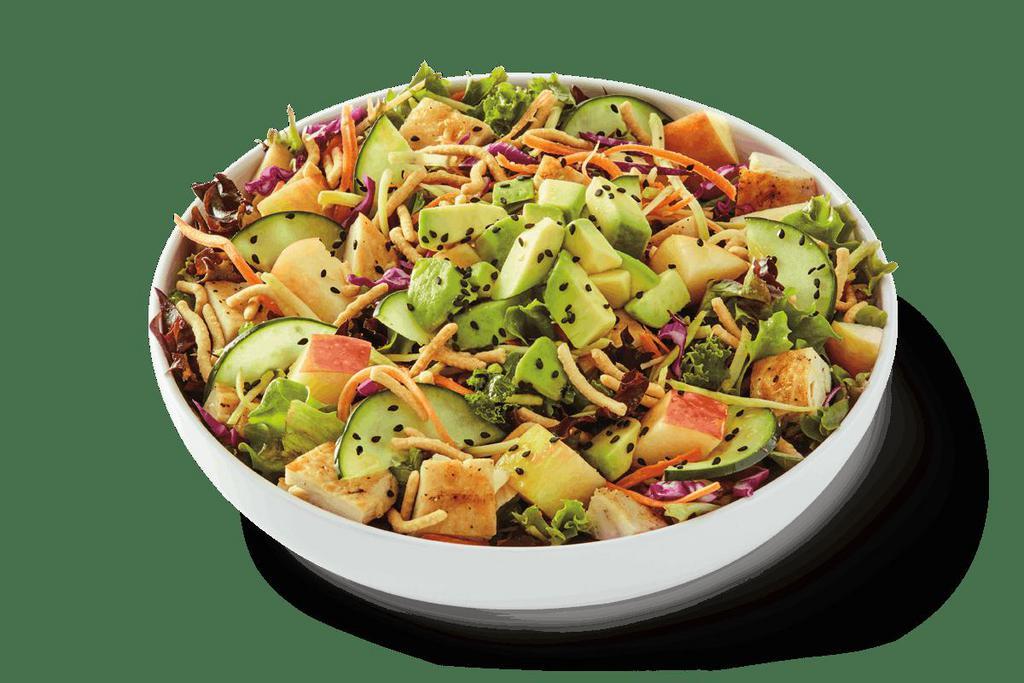 Asian Apple Citrus Salad · Tuscan greens and kale mix tossed in a ginger citrus dressing with grilled chicken, diced apple, cucumber and slaw made from broccoli, carrots and red cabbage topped with fresh avocado, crispy chow mein noodles and black sesame seeds.