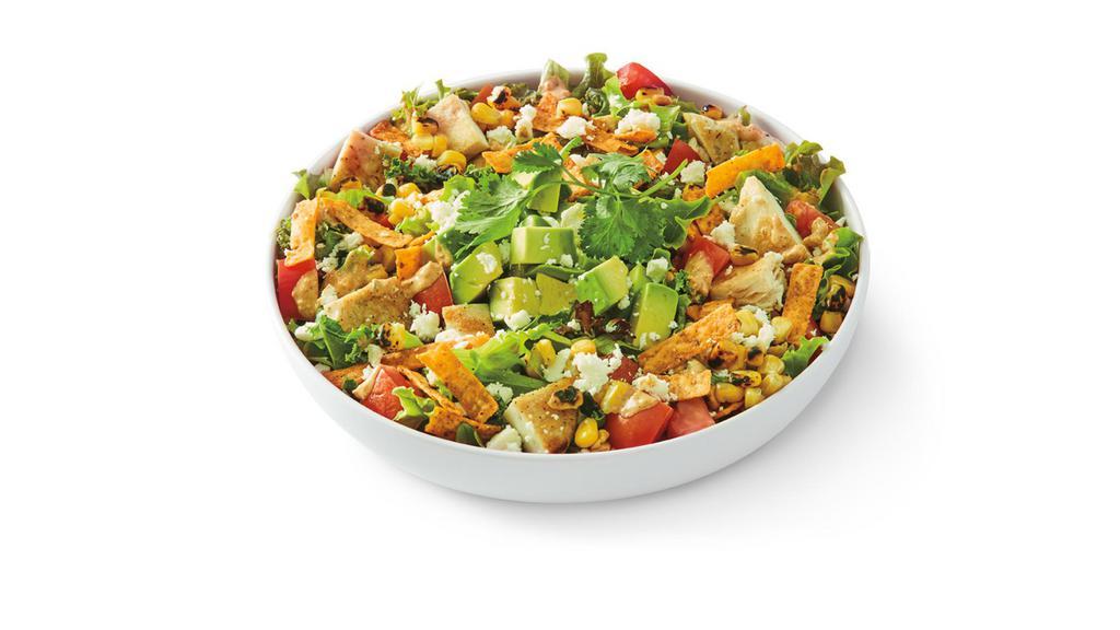 Mexican Street Corn Salad · Tuscan greens and kale mix tossed in cotija cheese dressing with grilled chicken, roasted corn and Roma tomato topped with avocado, feta, chipotle cheddar tortilla strips and cilantro.. G-S