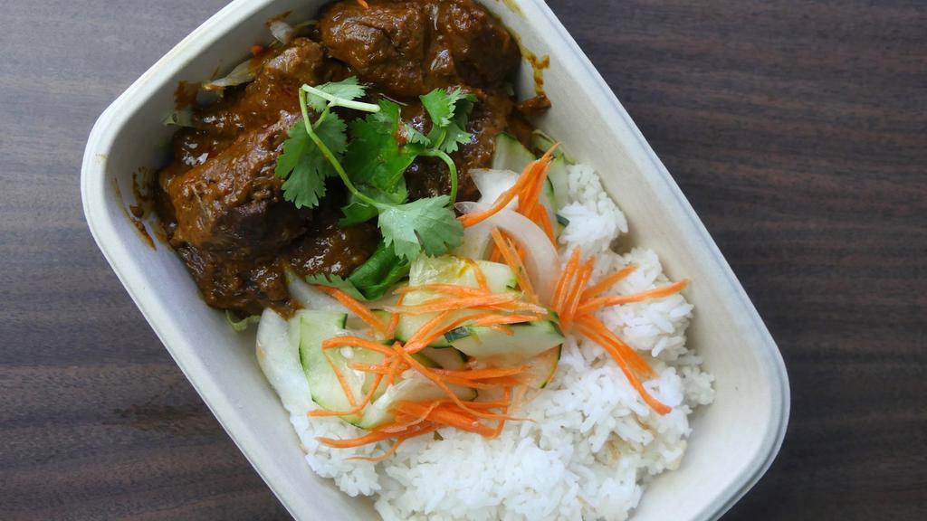 Rendang Beef with Coconut Rice · Slow cooked spiced infused beef, braised in coconut milk and lemongrass served with rice cooked in coconut milk accompanied by refreshing cucumber, onion and carrot pickle.