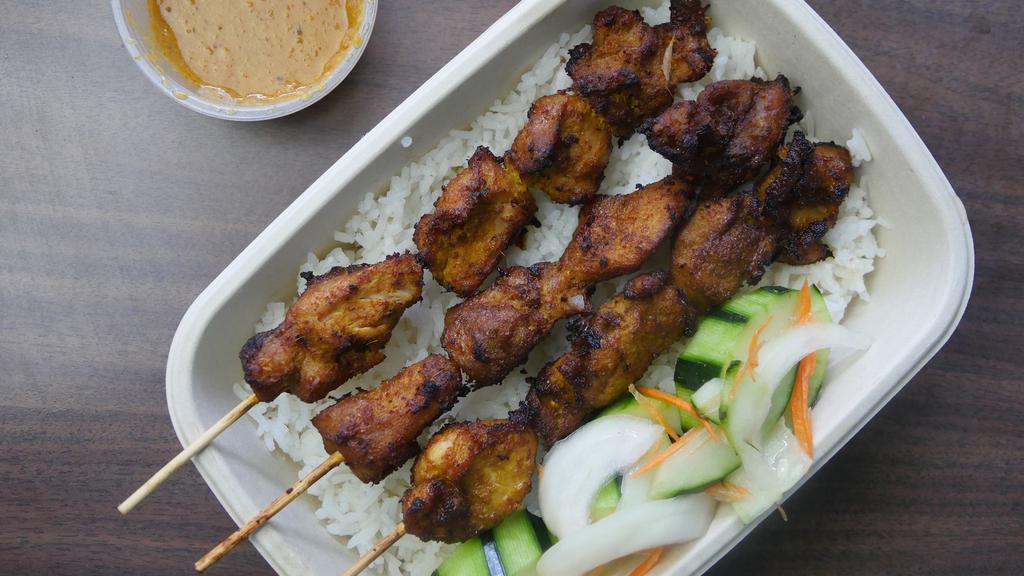 Chicken Skewers with Coconut Rice · 3 Chicken Skewers marinated in lemongrass spice, served with Coconut rice and cucumber garnish.