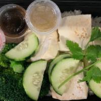 Tofu with Greens and Coconut Rice · Fresh organic tofu served with vegetables and coconut flavored rice.