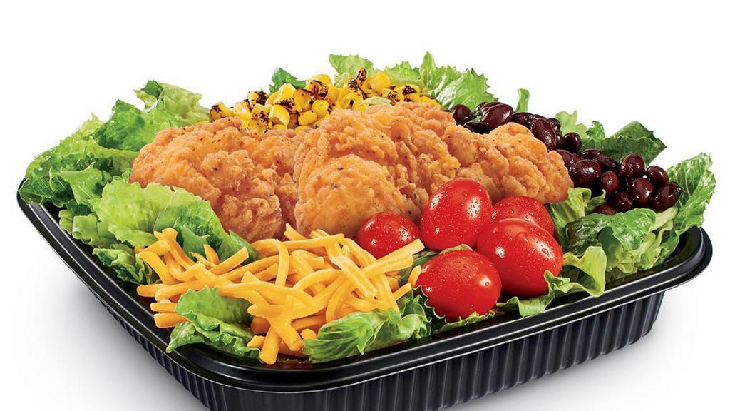 Southwest Chicken Salad (Crispy) · Iceberg and romaine lettuce blend topped with Crispy Chicken Strips, black beans, grape tomatoes, roasted corn, shredded Cheddar cheese, served with creamy Southwest dressing and spicy corn sticks