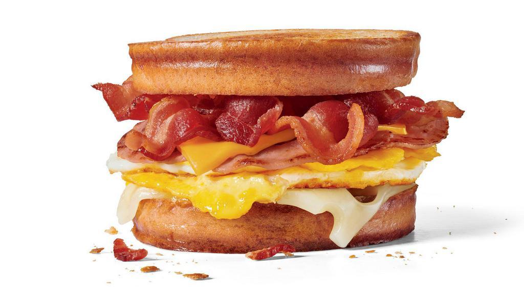 Grilled Sourdough Swiss Breakfast Sandwich · 2 slices of ham, 2 full strips of bacon, 2 fried eggs 1 slice of Swiss cheese and 1 slice of American cheese on grilled sourdough bread