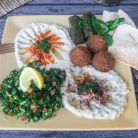 King Sampler Plate · Tabouli salad, hummus, baba ghanouj, dolma, 3 falafels and pita bread.