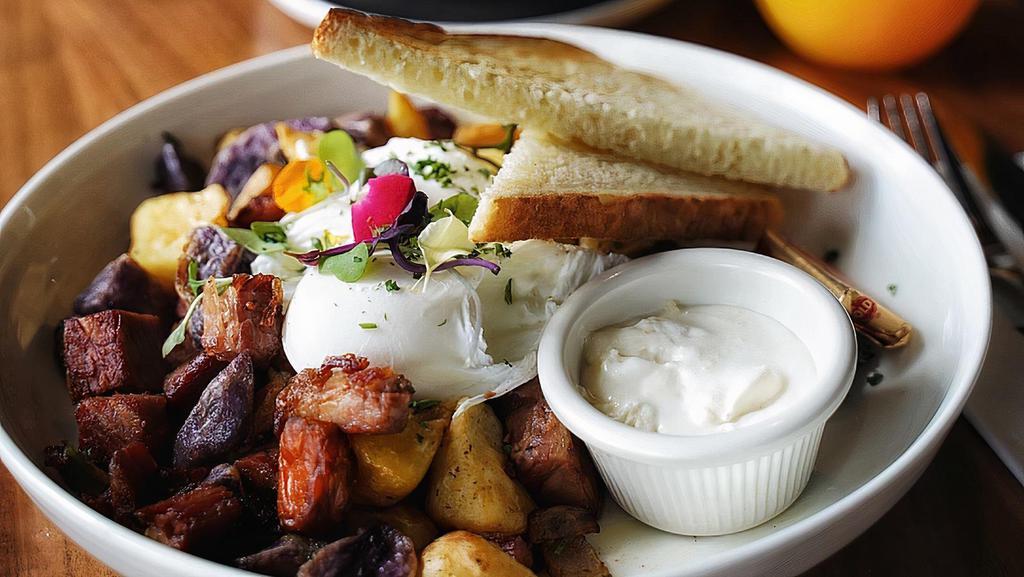 Chunky Corned Beef Hash · Two poached eggs, onion, bell peppers, potatoes, home-made horseradish cream.