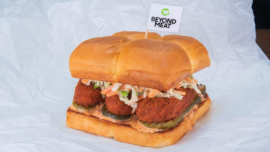 Beyond® The Hot Chick · Two crispy fried Beyond® tenders, spiced to your liking, Plain, Nashville Hot or Nashville Hotter with secret sauce, dill pickle slices and slaw; served on King's Hawaiian rolls.