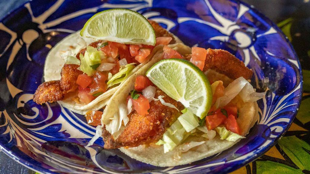 Fish Taco · Corn tortillas served with fried marinated fish, lightly breaded, onions, cilantro, and salsa brava.