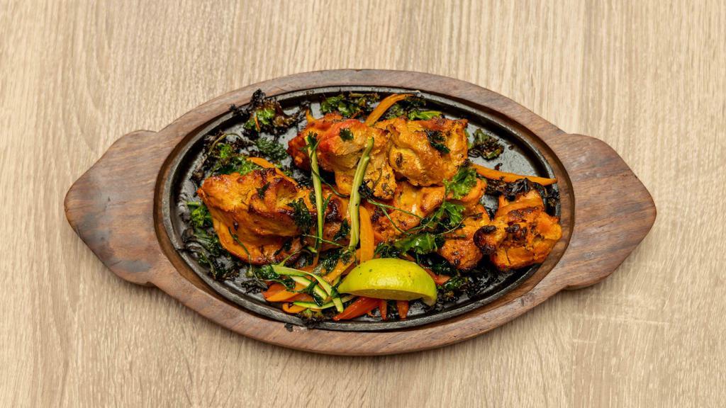 PESHAWARI CHICKEN TIKKA · The word Tikka means bits, pieces or chunks. Boneless pieces of chicken marinated in yogurt, spices and grilled on skewers in tandoor oven.