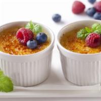 Creme Brulle & Berries · A layer of raspberry sauce topped with a creamy custard and decorated with mixed berries coa...