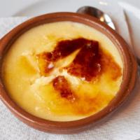 Coppa Catalana Cream Brulee · Creamy custard topped with caramelized sugar in a glass bowl.