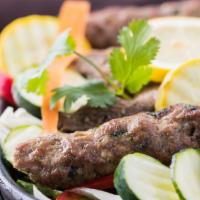 Seekh Kabab · Ground lamb with onions, fresh herbs and home-made spices, prepared on skewer.