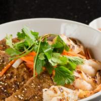 Vermicelli Bowl #9 · Spicy. Choice of marinated grilled beef, pork or chicken with 4 grilled prawns over vermicel...