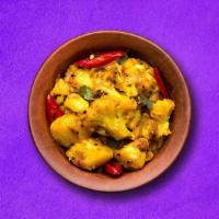 Cauli Potato Adventure  (Vegan) · Potato and cauliflower cooked together with onion, tomato and tossed with spices.