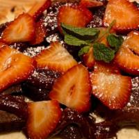 Fudge Brownie & Strawberry Flatbread · fudge brownie bites, hot fudge, fresh strawberries, powdered sugar.