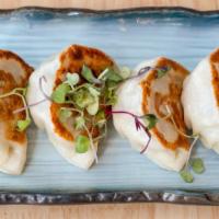 Pork Pot Stickers (4 Pieces) / 锅贴 · Pork, Napa cabbage, green onions wrapped in wheat flour skin and deep-fried. Served with hom...