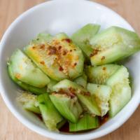 Cucumber Salad / 拍黄瓜 · Fresh cut cucumbers mixed with minced garlic and salt served in hot chili oil sauce.