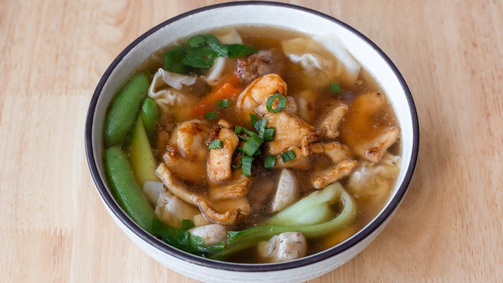 Wonton Soup / 窝云吞汤 · Pork wontons, snap peas, carrots and mushroom cooked in chicken broth. Topped with chicken, beef and shrimp.