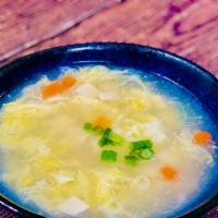 Egg Drop Soup/ 蛋花汤 · Wispy beaten eggs in chicken broth. comes with green peas
and carrot, finely chopped scallio...