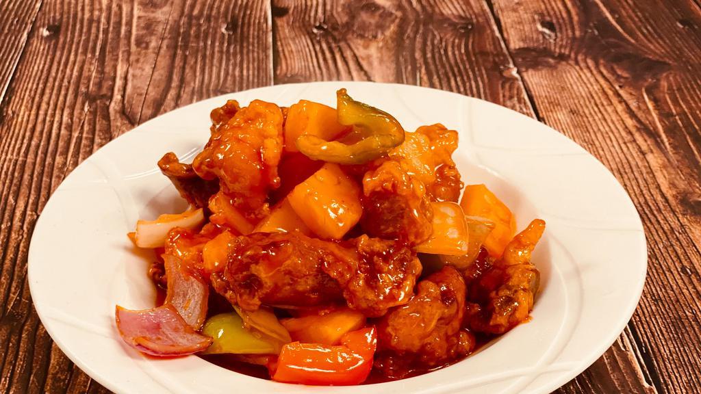 Sweet & Sour Chicken / 古老鸡  · Deep-fried chicken nuggets stir-fried with pineapple, bell peppers and white onions in sweet and sour sauce.