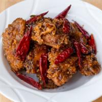 Dry Fried Chicken Wings / 干烹鸡翅 · Deep-fried wings mixed into our delicious sweet and spicy sauce with chili peppers and green...
