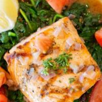 *Grilled Salmon · Fresh grilled salmon served with a side of sautéed spinach with olive oil & garlic, topped w...