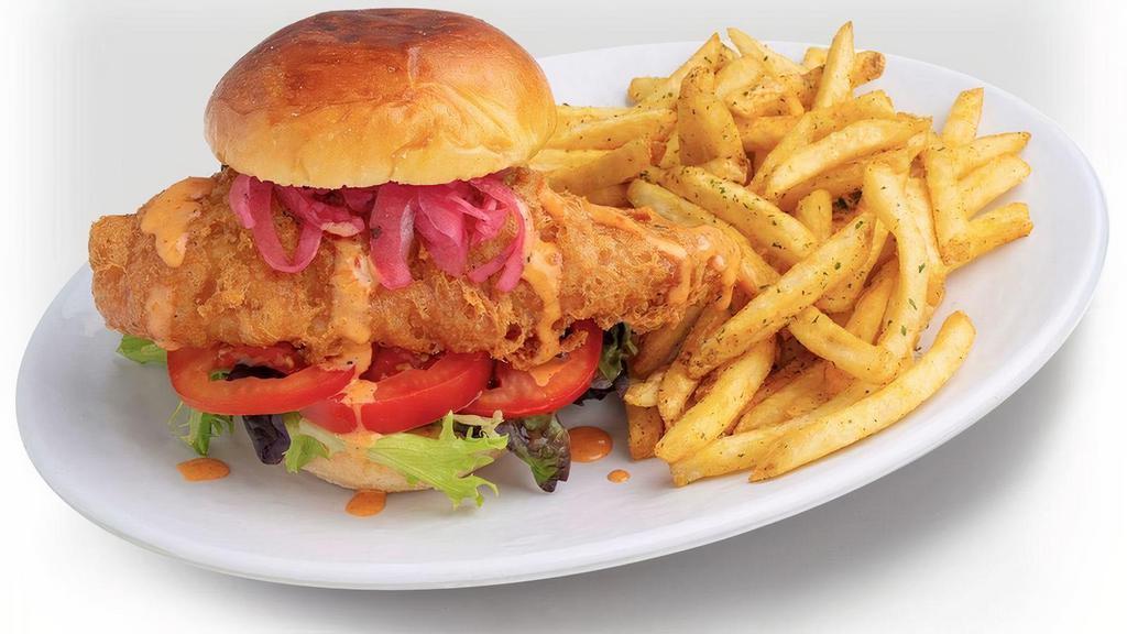 Crispy Fish Sandwich · Grilled Brioche Bun, Mixed Greens, Tartar Sauce & Dynamite Sauce, Tomatoes, Pickled Onions. Accompanied with choice of side.