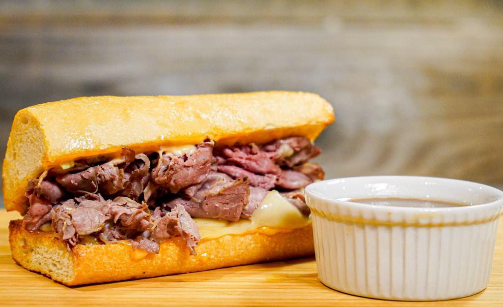 French Dip · Thinly Sliced Roast Beef, House Spread, Swiss Cheese, and All-Natural Au Jus.