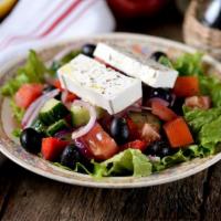 Greek Salad · Crisp lettuce, feta cheese, stuffed grape leaves, tomato, olives, and onions.