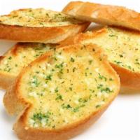 Baked Garlic Bread · Fresh bread topped with herbs and garlic baked until golden-brown.