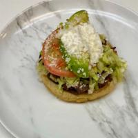 Sopes · Refried beans, lettuce, tomato, avocado, cheese, and choice of meat.