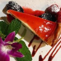 Papillon Housemade Cheesecake with Seasonal Fruit Coulis · 